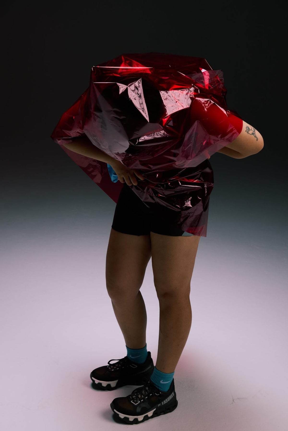 B.Peachy campaign portrait with a red sculptural prop