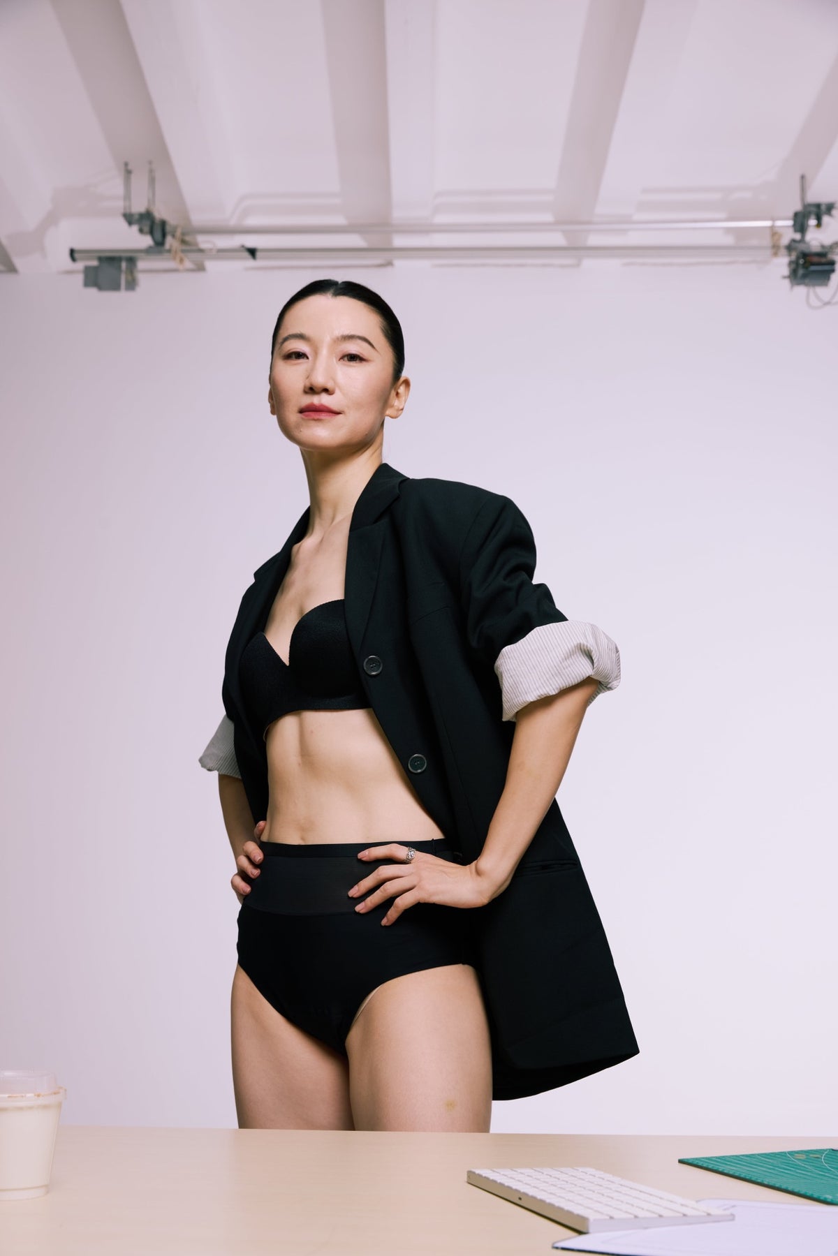 Black high-waist briefs with a mesh waistband, worn with a black blazer