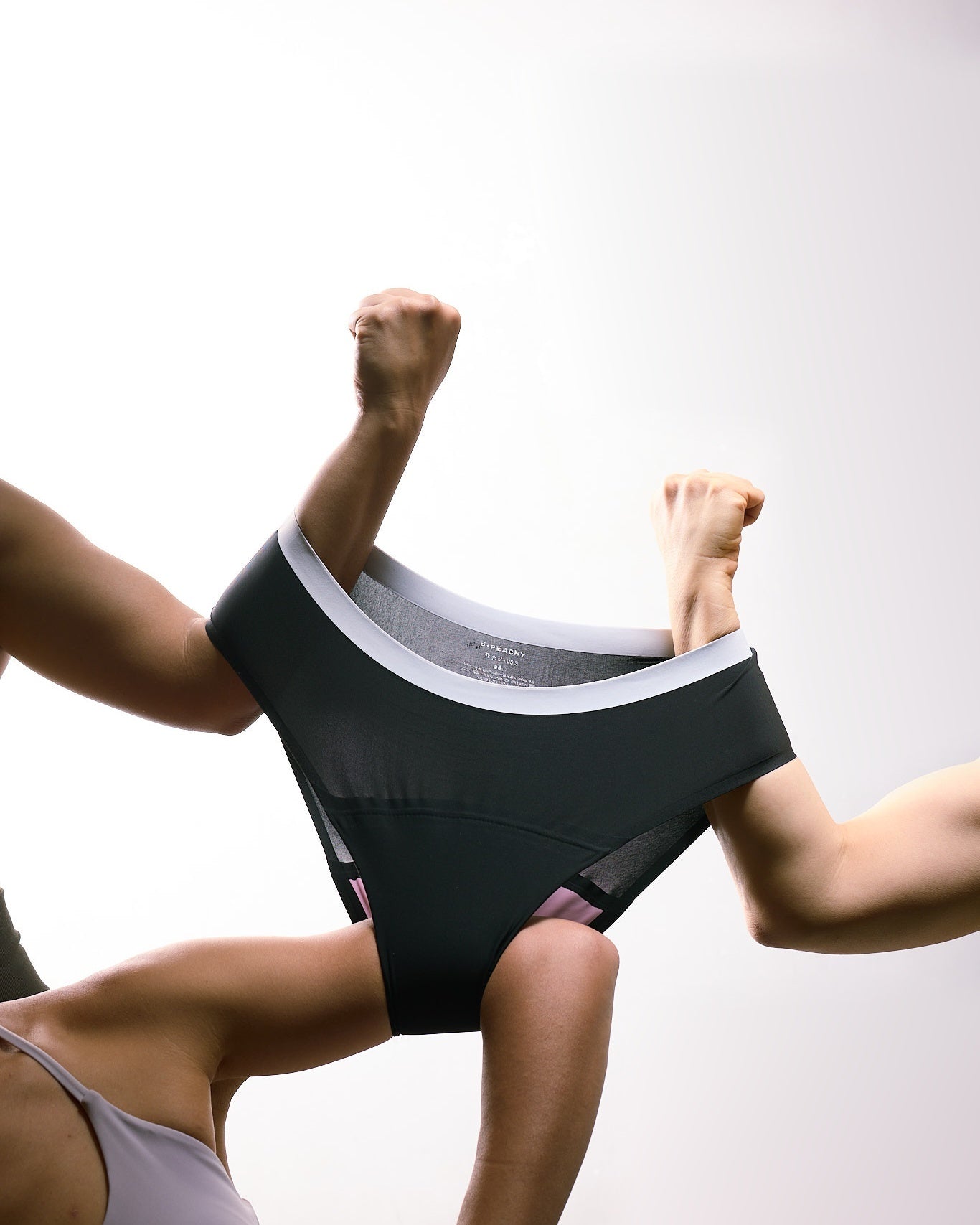 Black Classic Briefs 2.0 stretched between arms to show fabric flexibility